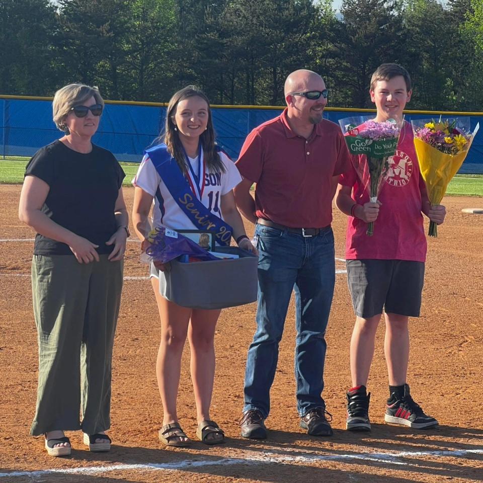 Ellie Buckner, who plays second base for Madison High, is pictured here with her parents on the team's senior night.