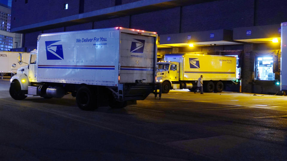 Delivery trucks arrive at the loading dock at the United States Postal Service sorting and processing facility, Thursday, Nov. 18, 2021, in Boston. Last year's holiday season was far from the most wonderful time of the year for the beleaguered U.S. Postal Service. Shippers are now gearing up for another holiday crush. (AP Photo/Charles Krupa)