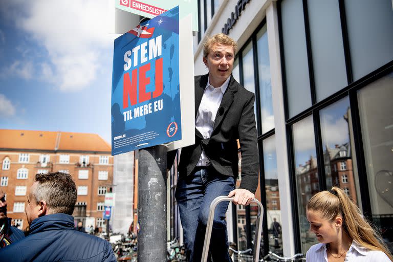 El presidente del Partido Popular Danés, Morten Messerschmidt, cuelga un cartel con la leyenda en danés "Vota no a más UE", en Amagerbro en Copenhague, el sábado 7 de mayo de 2022. 