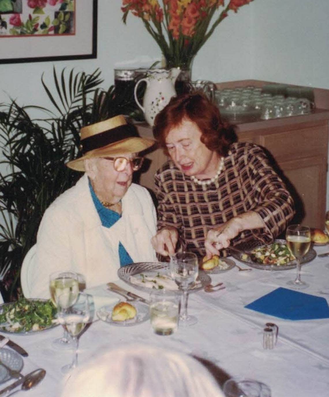 Preservationist Sallye Jude, at right, helps environmentalist and author Marjory Stoneman Douglas, a close friend whose care she helped oversee, at a 105th birthday dinner in 1995 at the family’s Miami River Inn.