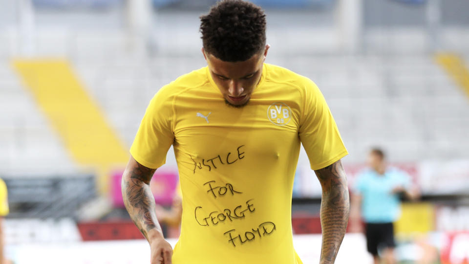 Jadon Sancho celebrates scoring his teams second goal of the game with a 'Justice for George Floyd' shirt. (Photo by Lars Baron/Getty Images)