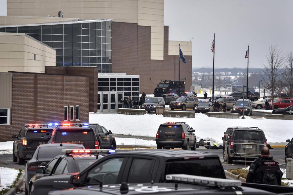 Image: Dozens of police, fire, and EMS personnel work on the scene of a shooting at Oxford High School on Nov. 30, 2021, In Oxford Township, Mich. (Todd McInturf / The Detroit News via AP)