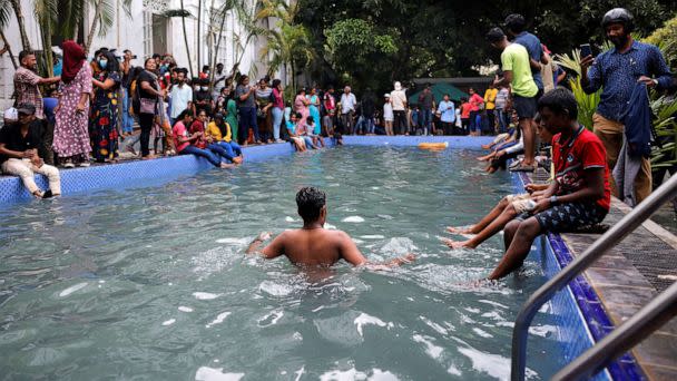 PHOTO: A man stands in the swimming pool as people visit the President's house on the day after demonstrators entered the building, after President Gotabaya Rajapaksa fled, amid the country's economic crisis, in Colombo, Sri Lanka, July 10, 2022. (Dinuka Liyanawatte/Reuters)