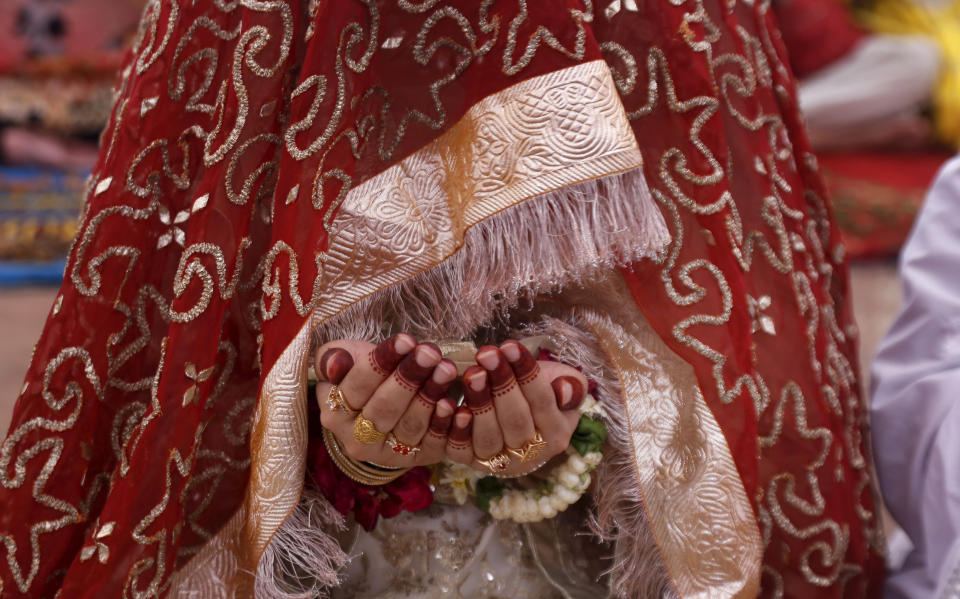 A Muslim bride prays while she attend last Friday prayer during the holy fasting month of Ramadan, at the historical Badshahi mosque, in Lahore, Pakistan, Friday, May 7, 2021. (AP Photo/K.M. Chaudary)