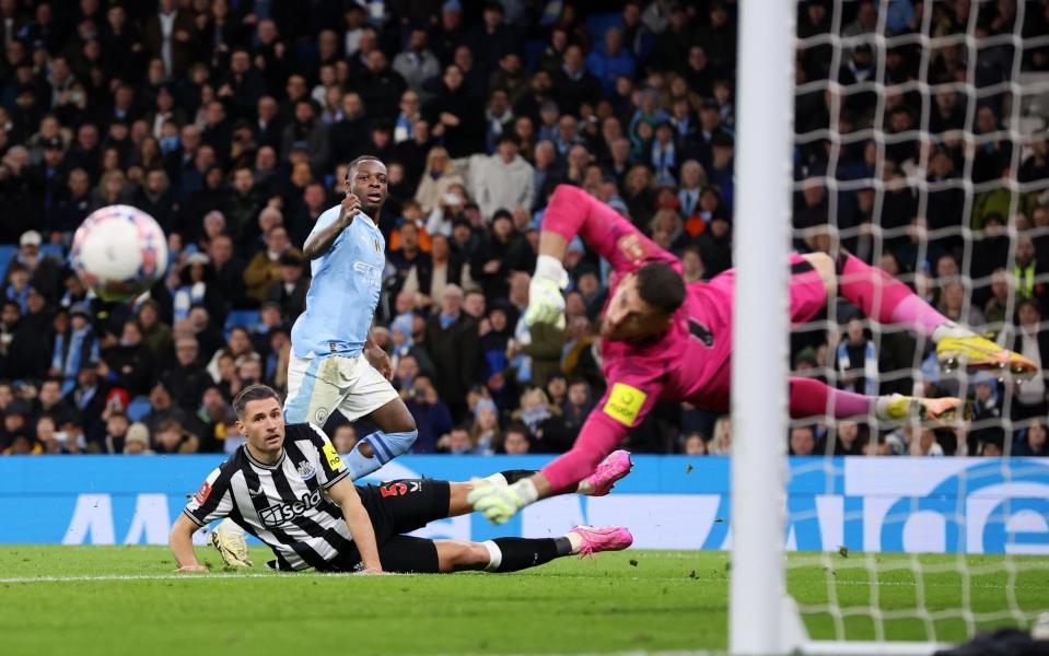 Newcastle goalkeeper Martin Dubravka saves from Manchester City player Jeremy Doku