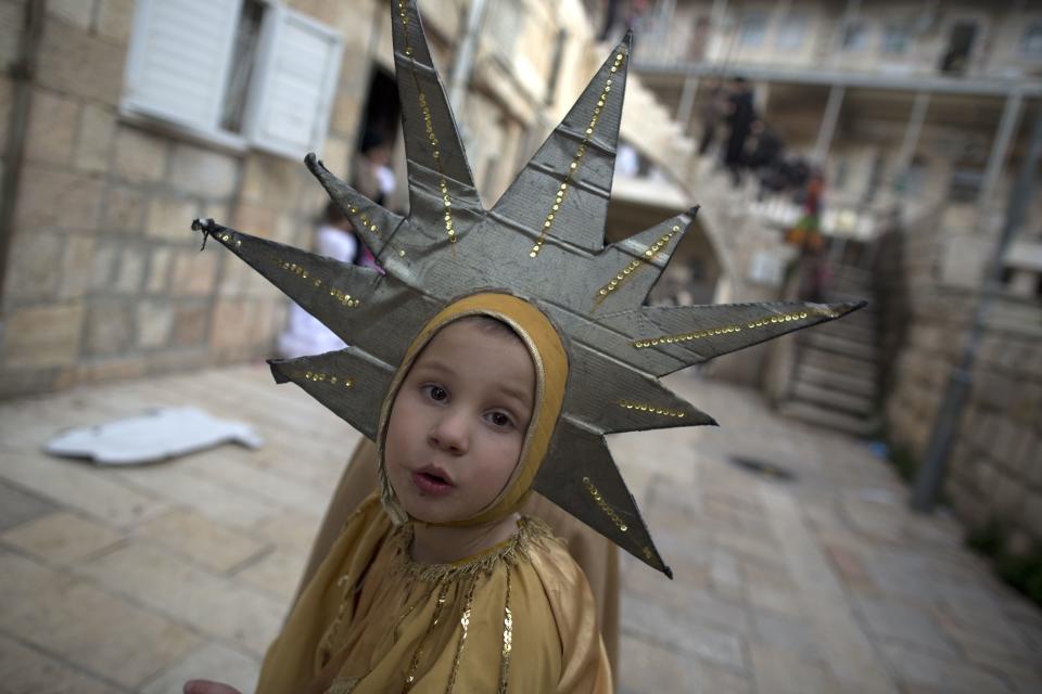 An Ultra-Orthodox Jewish boy wears a Purim costume as he celebrates the Jewish festival of Purim on February 25 2013 in the religious neighborhood of Mea Shearim in Jerusalem. (Menahem Kahana/AFP/Getty Images)