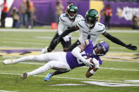 Minnesota Vikings wide receiver Justin Jefferson (18) catches a pass ahead of New York Jets cornerback Sauce Gardner (1) during the first half of an NFL football game, Sunday, Dec. 4, 2022, in Minneapolis. (AP Photo/Bruce Kluckhohn)