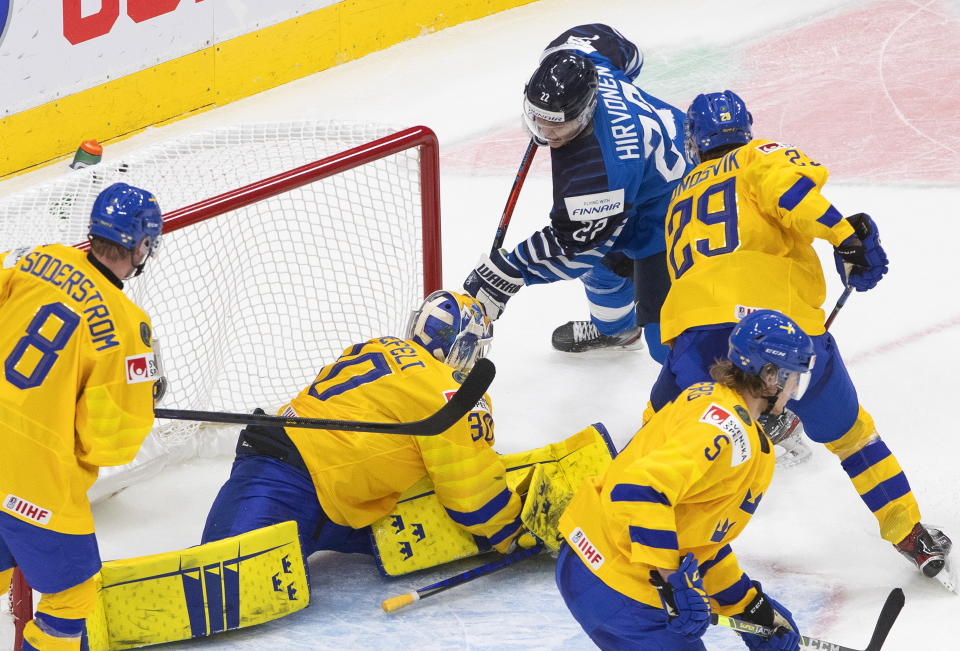 Sweden's goalie Hugo Alnefelt (30) is scored on by Finland's Roni Hirvonen (22) during the third period of an IIHL World Junior Hockey Championship game, Saturday, Jan. 2, 2021 in Edmonton, Alberta. (Jason Franson/The Canadian Press via AP)