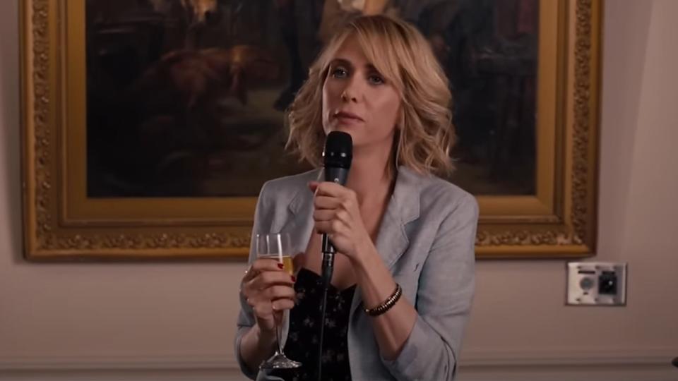 Kristen Wiig holding a mic in Bridesmaids.