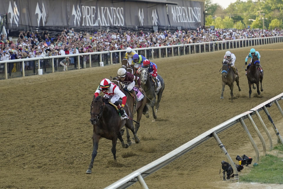 Jose Ortiz, left, atop Early Voting, wins the 147th running of the Preakness Stakes horse race at Pimlico Race Course, Saturday, May 21, 2022, in Baltimore. (AP Photo/Julio Cortez)