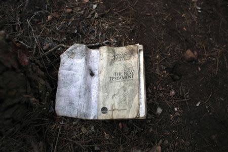 A copy of the Bible lies on the ground at a clandestine campsite named Bolingo in northern Morocco near the border fence with Spain's north African enclave Melilla November 28, 2013. REUTERS/Juan Medina