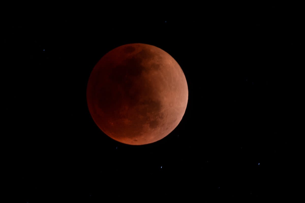 The blood moon is seen during a total lunar eclipse in Canta, east of Lima on May 15, 2022. (Photo by ERNESTO BENAVIDES / AFP) (Photo by ERNESTO BENAVIDES/AFP via Getty Images) (AFP via Getty Images)