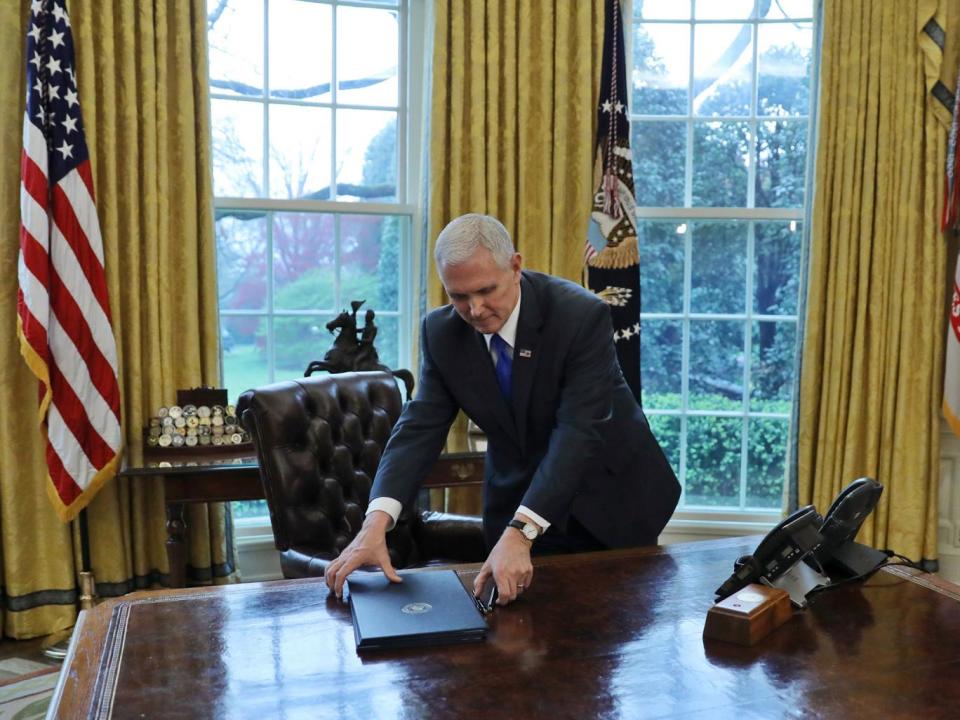 Vice President Mike Pence was left to collect the executive orders Donald Trump had been due to sign on 31 March (Reuters)