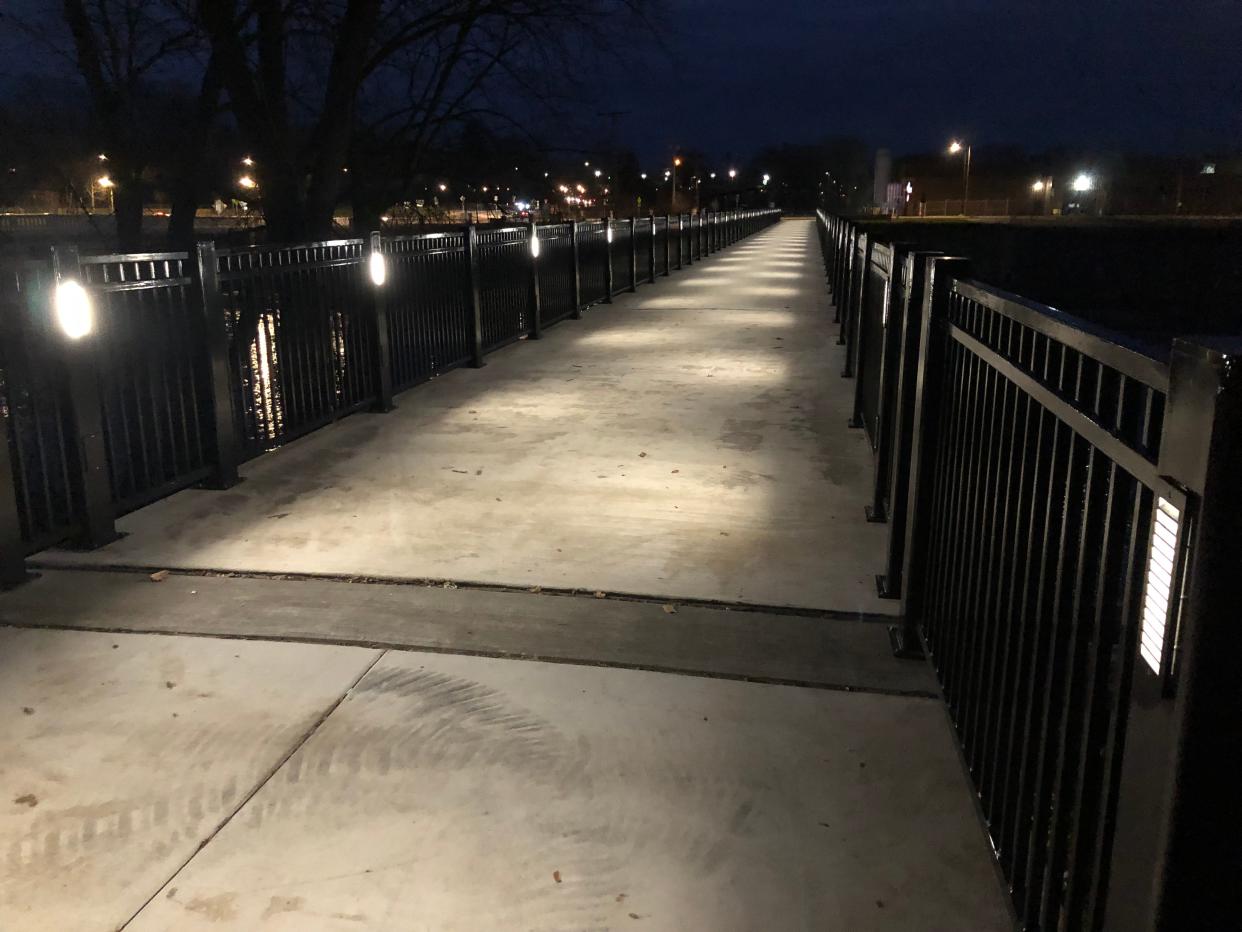 Embedded in the metal posts, lights shine down on the newly opened Coal Line Trail bridge over the St. Joseph River in South Bend, seen here on Dec. 16, 2023.