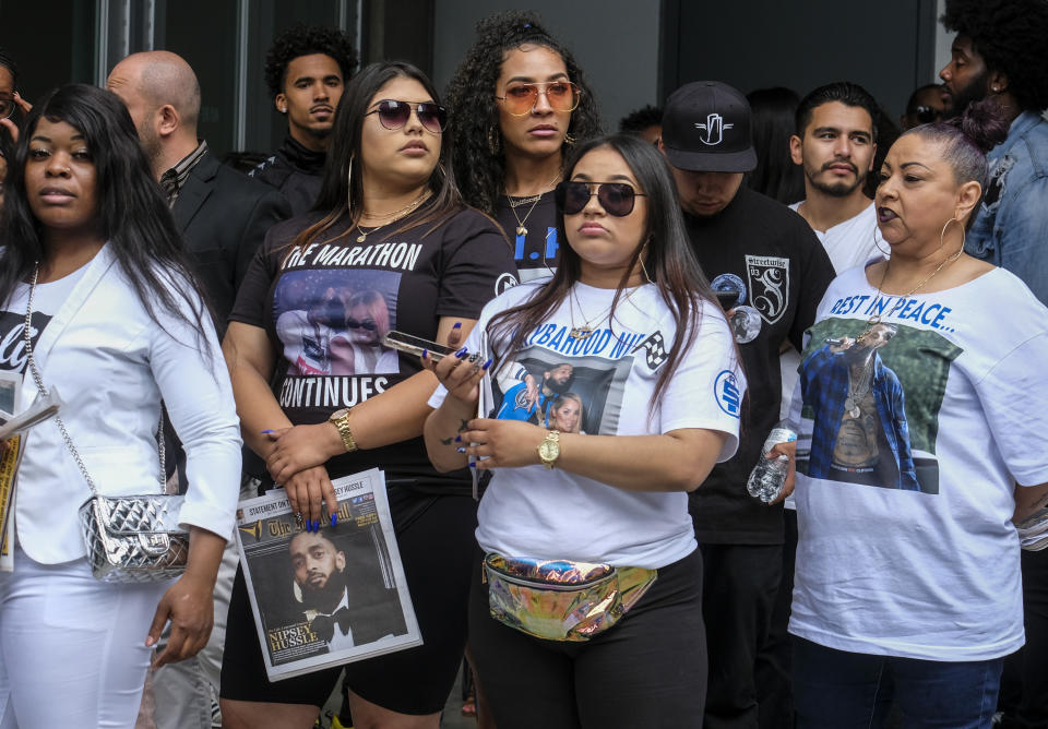 Fans of rapper Nipsey Hussle wait in line to attend his public memorial service at Staples Center in Los Angeles, Thursday, April 11, 2019. Hussle was killed in a shooting outside his Marathon Clothing store in south Los Angeles on March 31. (AP Photo/Ringo H.W. Chiu)