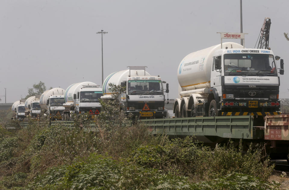 FILE- In this April 19, 2021 file photo, empty tankers are loaded on a train wagon at the Kalamboli goods yard in Navi Mumbai, Maharashtra state, India, before they are transported to collect liquid medical oxygen from other states. The western Maharashtra state, which is worst hit by the coronavirus is facing a shortage of the gas used for the treatment of COVID-19 patients. India's health system is collapsing under the worst surge in coronavirus infections that it has seen so far. (AP Photo/Rafiq Maqbool, File)