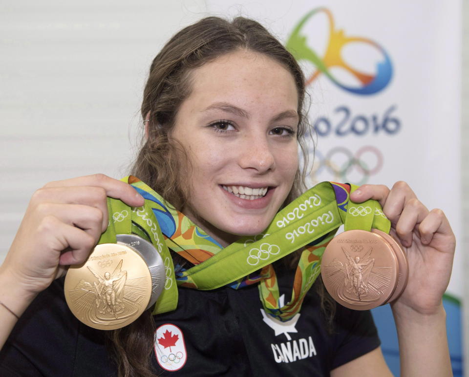 Canada's Penny Oleksiak, from Toronto, holds up her four medals, a gold, silver and two bronze, she won at the 2016 Summer Olympics. (THE CANADIAN PRESS/Ryan Remiorz)