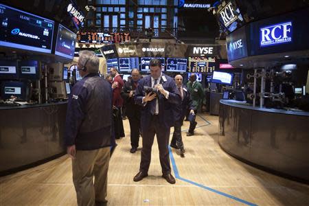 Traders work on the floor of the New York Stock Exchange in New York March 18, 2014. REUTERS/Carlo Allegri