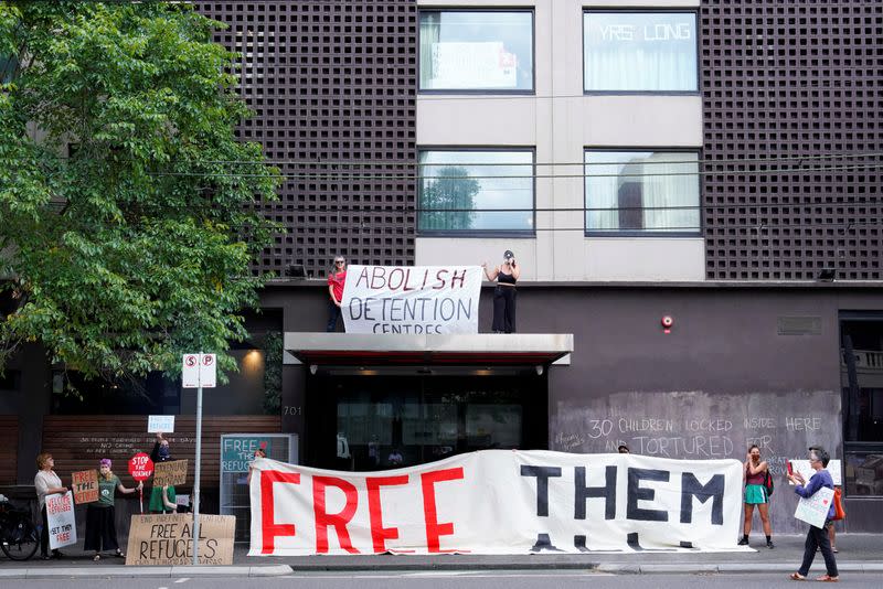 Pro-refugee protestors demonstrate at the Park Hotel, where Serbian tennis player Novak Djokovic is believed to be staying, in Melbourne