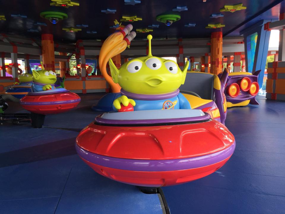 The Pizza Planet aliens from Toy Story take guests out for a spin.