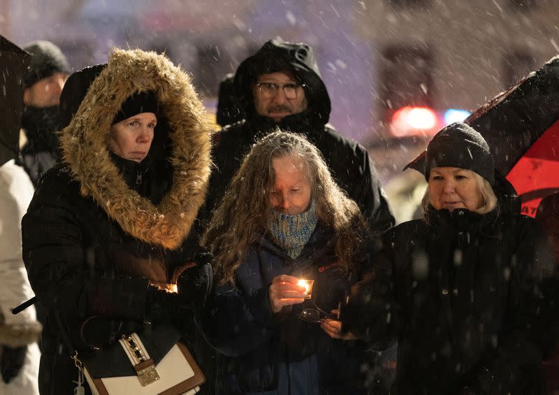 People attend a vigil in honour of the victims of the daycare bus crash victims in Laval, Quebec