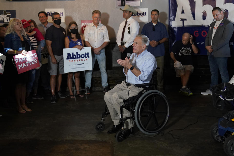 Texas Gov. Greg Abbott, center, talks with supporters as he prepares to canvass for votes, Saturday, Oct. 1, 2022, in Harlingen, Texas. As Democrats embark on another October blitz in pursuit of flipping America's biggest red state, Republicans are taking a swing of their own: Making a play for the mostly Hispanic southern border on Nov. 8 after years of writing off the region that is overwhelmingly controlled by Democrats. (AP Photo/Eric Gay)