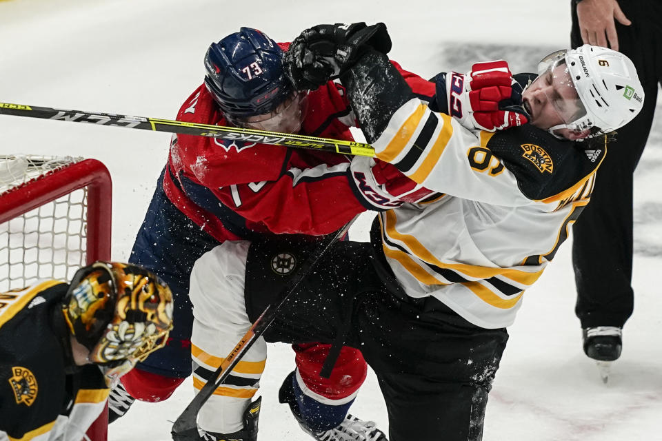 Washington Capitals left wing Conor Sheary (73) and Boston Bruins defenseman Mike Reilly (6) scuffle during the first period of Game 2 of an NHL hockey Stanley Cup first-round playoff series Monday, May 17, 2021, in Washington. (AP Photo/Alex Brandon)