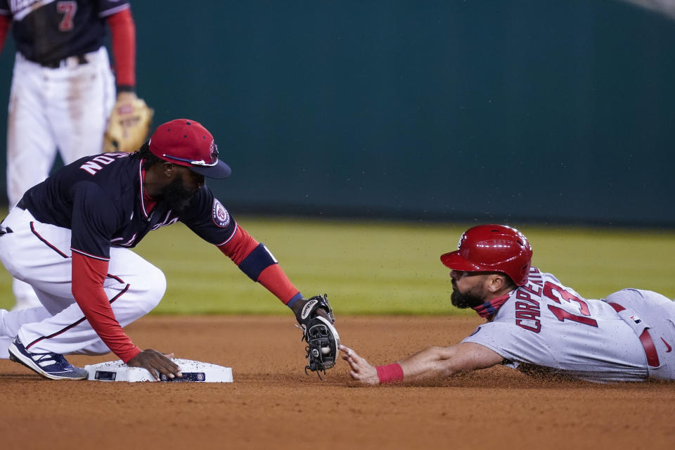 St Louis Cardinals' Matt Carpenter, right, is out at second base on the tag by Washington Nationals second baseman Josh Harrison, left, as he tries to reach second on his RBI single, during the fourth inning of a baseball game at Nationals Park, Monday, April 19, 2021, in Washington. (AP Photo/Alex Brandon)