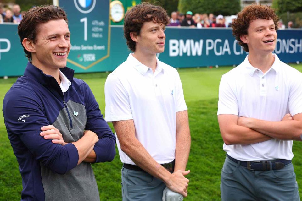 <p>Andrew Redington/Getty</p>  Tom Holland, Sam Holland and Harry Holland interact on the 1st tee during the Pro-Am prior to the BMW PGA Championship at Wentworth Golf Club on September 13, 2023 in Virginia Water, England.