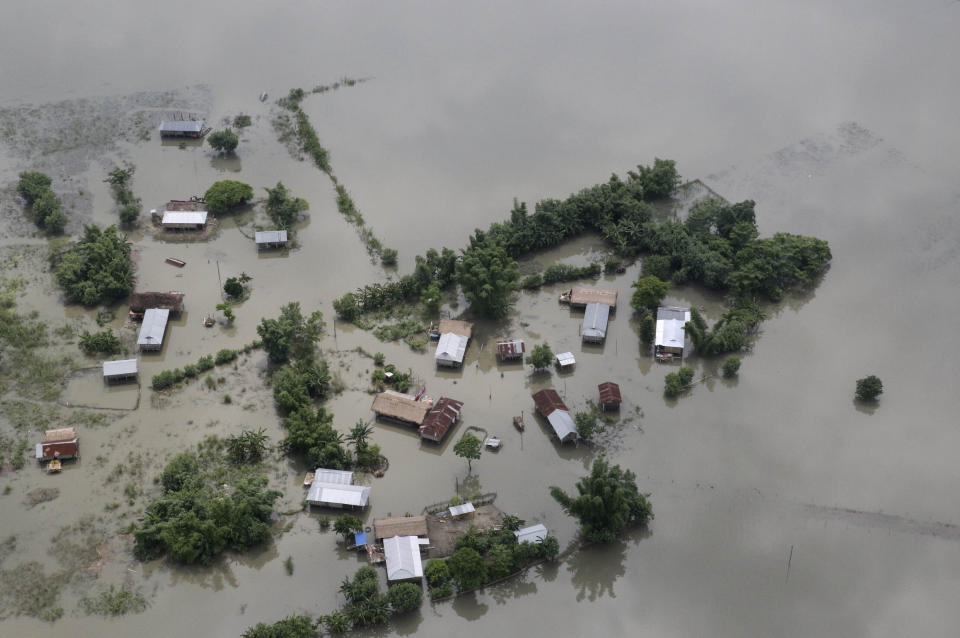 Homes are surrounded with floodwater from the River Brahmaputra, in Assam, India, July 16, 2019. (AP Photo)