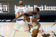 New York Knicks guard RJ Barrett, right, dribbles around a screen set by Taj Gibson (67) on Los Angeles Clippers guard Paul George, center, during the second half of an NBA basketball game Sunday, May 9, 2021, in Los Angeles. (AP Photo/Marcio Jose Sanchez)