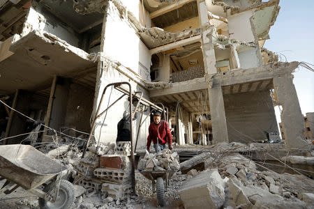 Workers work at a construction site in Ein Terma, a district of eastern Ghouta, Syria February 26, 2019. REUTERS/Omar Sanadiki