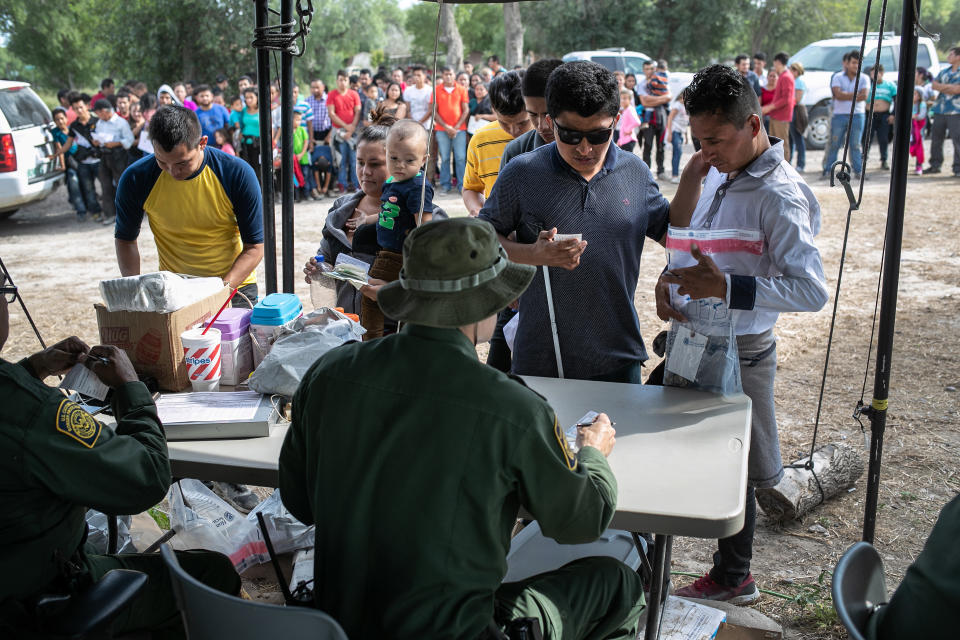 U.S. Border Patrol agents interview immigrants, including a blind man from El Salvador, after taking them into custody in July in Los Ebanos, Texas. (Photo: John Moore via Getty Images)