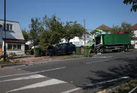 The scene of a collision in Broad Walk, Kidbrooke, south-east London, where the driver of a lorry which hit two cars before crashing into a house has died and an 11-year-old child is in a life-threatening condition in hospital.