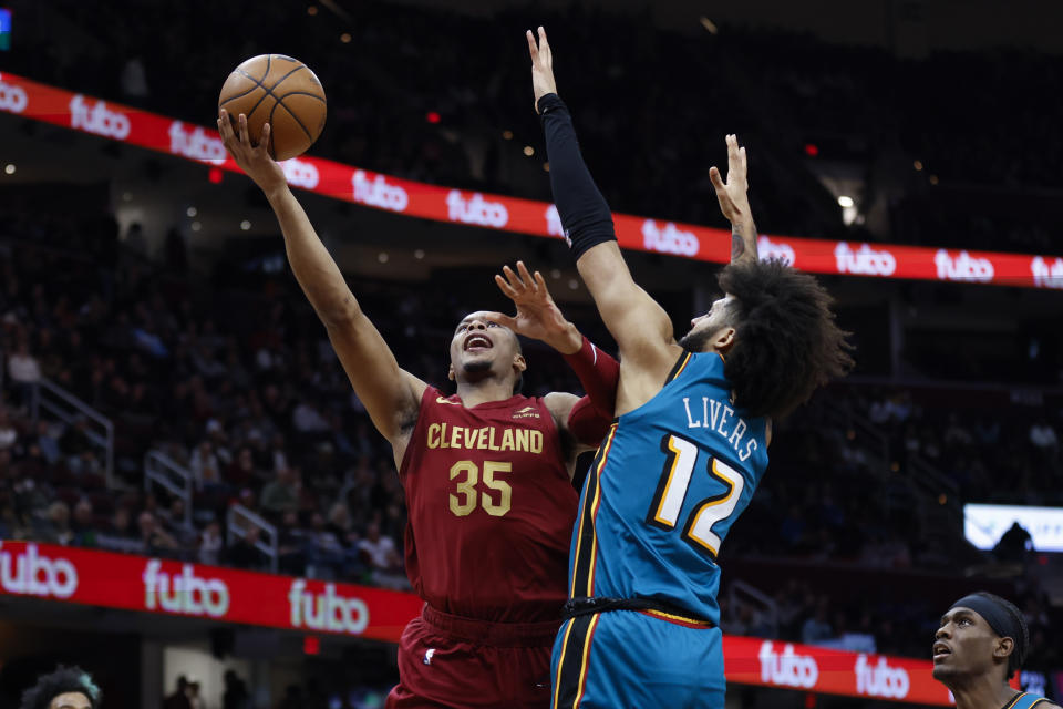 Cleveland Cavaliers forward Isaac Okoro (35) shoots against Detroit Pistons forward Isaiah Livers (12) during the second half of an NBA basketball game, Wednesday, Feb. 8, 2023, in Cleveland. (AP Photo/Ron Schwane)