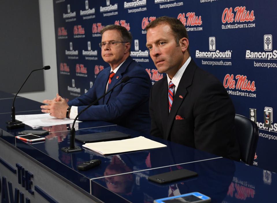 University of Mississippi Chancellor Jeffrey Vitter, left, and athletic director Ross Bjork speak at a news conference about the resignation of football coach Hugh Freeze on July 20, 2017.