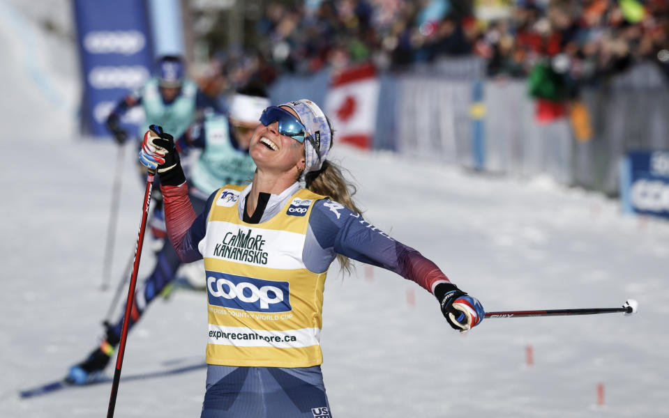 Jessie Diggins, of the United States, celebrates her win in the women's 15km Mass Start freestyle World Cup cross country skiing event in Canmore, Alberta, Friday, Feb. 9, 2024. (Jeff McIntosh/The Canadian Press via AP)