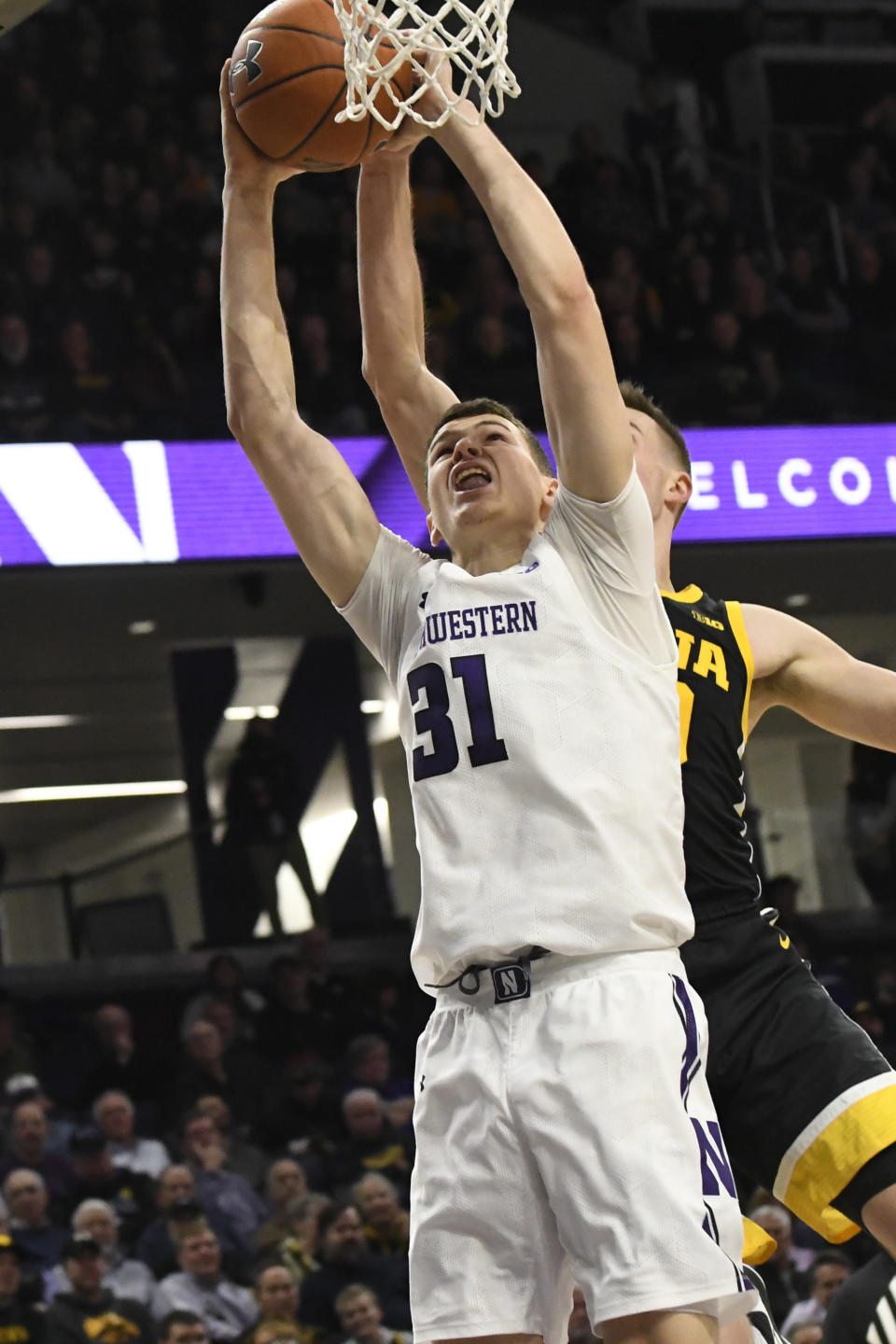 Northwestern forward Robbie Beran (31) has his shot blocked by Iowa guard Joe Wieskamp during the second half of an NCAA college basketball game Tuesday, Jan. 14, 2020, in Evanston, Ill. (AP Photo/David Banks)