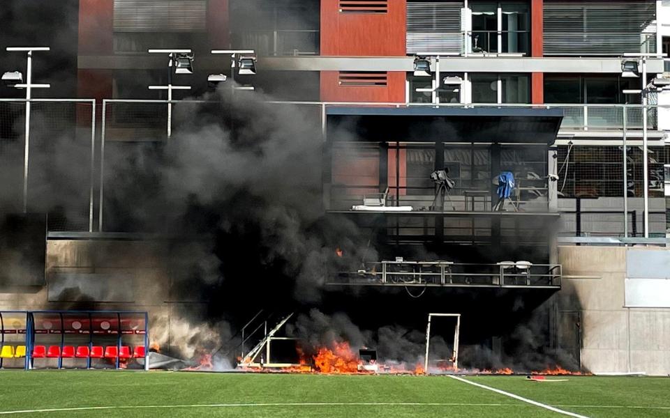 The fire took hold just a few metres away from the apartment blocks that overlook the pitch - PA