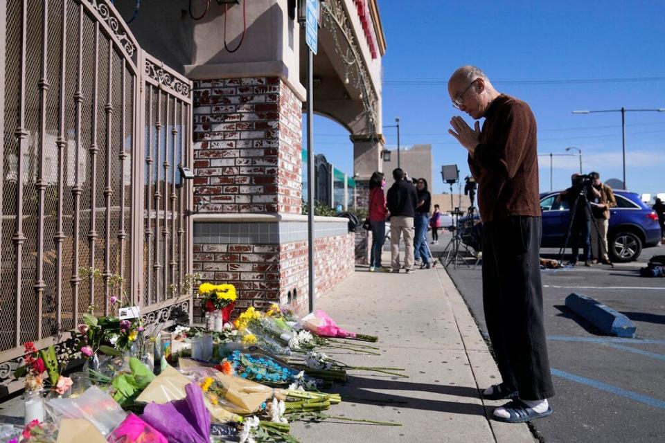 Kenny Loo, 71, prays outside Star Dance Studio for the victims killed in Saturday's shooting in Monterey Park, Calif., Monday, Jan. 23, 2023.