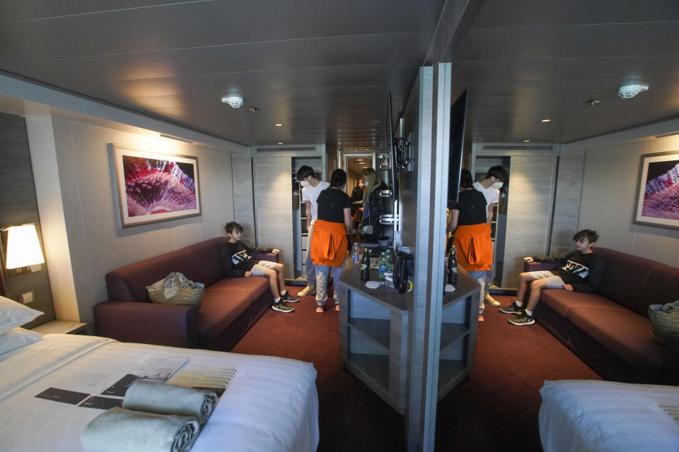 Passengers, from left, Dasteen and Samuel Pacifici, and Stefania Battistoni and Loredana Merlo enter their cabin after boarding the MSC Grandiosa cruise ship in Civitavecchia, near Rome, Wednesday, March 31, 2021. MSC Grandiosa, the world's only cruise ship to be operating at the moment, left from Genoa on March 30 and stopped in Civitavecchia near Rome to pick up more passengers and then sail toward Naples, Cagliari, and Malta to be back in Genoa on April 6. For most of the winter, the MSC Grandiosa has been a lonely flag-bearer of the global cruise industry stalled by the pandemic, plying the Mediterranean Sea with seven-night cruises along Italy’s western coast, its major islands and a stop in Malta. (AP Photo/Andrew Medichini)