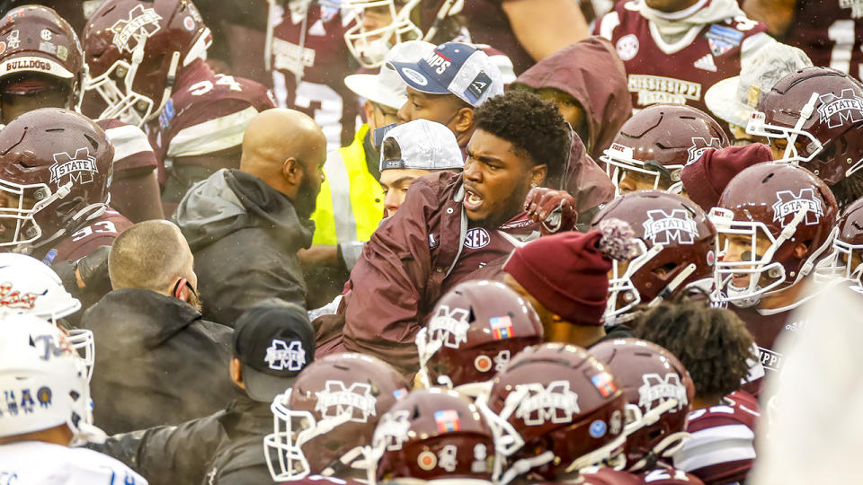 A fight breaks out after the game cancelling the trophy presentation after the Armed Forces Bowl game between the Tulsa Golden Hurricane and the Mississippi State Bulldogs. (Photo by Matthew Pearce/Icon Sportswire via Getty Images)