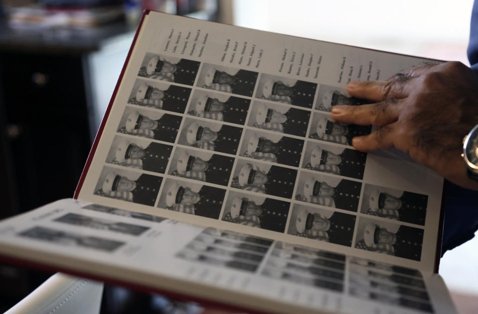 Mansoor Shams looks through photos from his time in the Marines, Friday Aug. 13, 2021 at his home in Baltimore. (AP Photo/Jessie Wardarski)