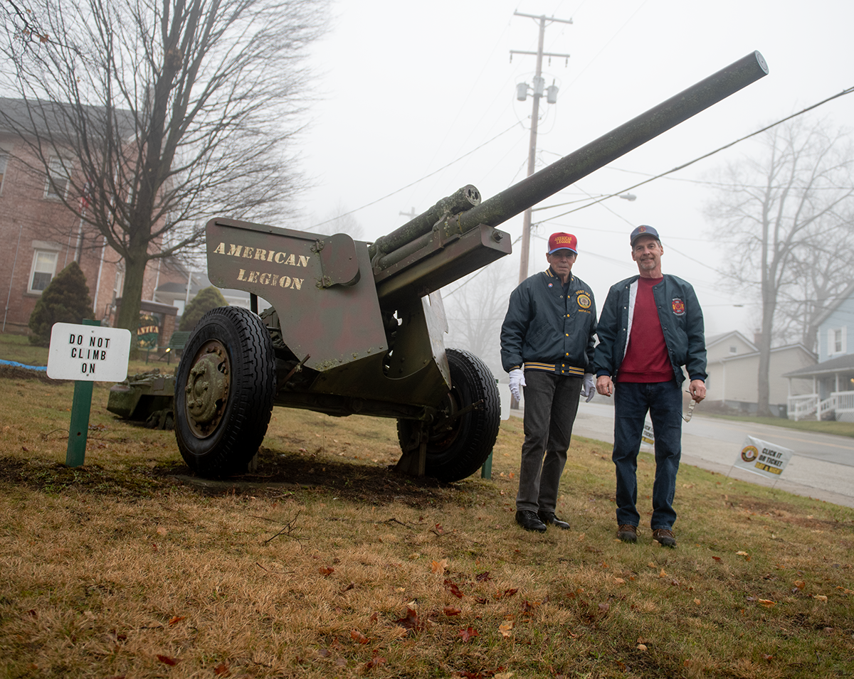 The World War II cannon outside Mantua Village Hall will be rededicated Saturday. David Pifer, service officer of Mantua American Legion Post 193, and Mantua-Shalersville Firefighter Tim Benner,  shown by the cannon last January, worked this year to raise funds for an informational plaque on the gun and a plaque honoring local residents killed in action.