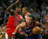 New York Knicks guard Jalen Brunson (11) dribbles around Chicago Bulls forward Torrey Craig (13) during the first half of an NBA basketball game Sunday, April 14, 2024, in New York. (AP Photo/John Munson)