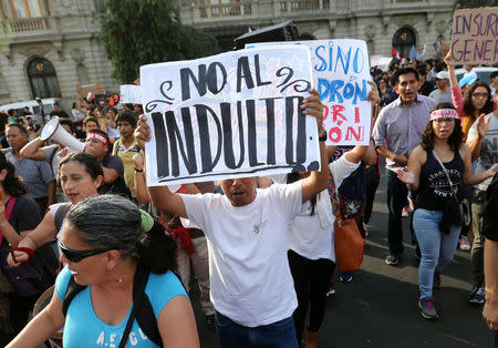 Protesters holding sign reading 'No Pardon' march after Peruvian President Pedro Pablo Kuczynski pardoned former President Alberto Fujimori in Lima, Peru, December 25, 2017. REUTERS/Mariana Bazo