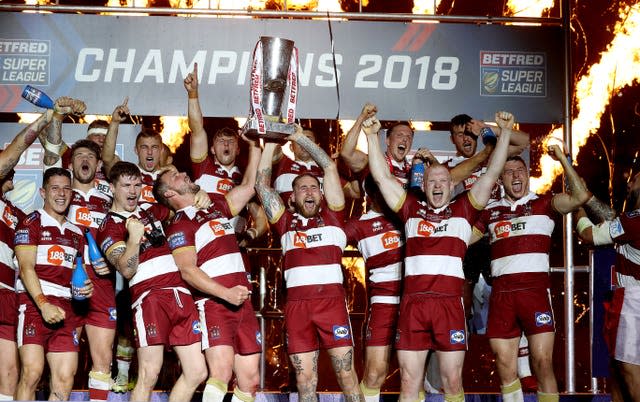 Tomkins (centre) with the trophy after Wigan's 2018 Grand Final triumph (Martin Rickett/PA).