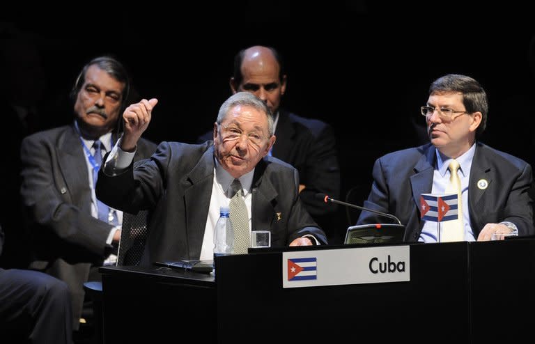 In a picture released by the Chilean Presidency, Cuban President Raul Castro (L) delivers a speech as his Foreign Minister Bruno Rodriguez looks on at the Latin American and Caribbean States (CELAC) Summit in Santiago, on January 28, 2013