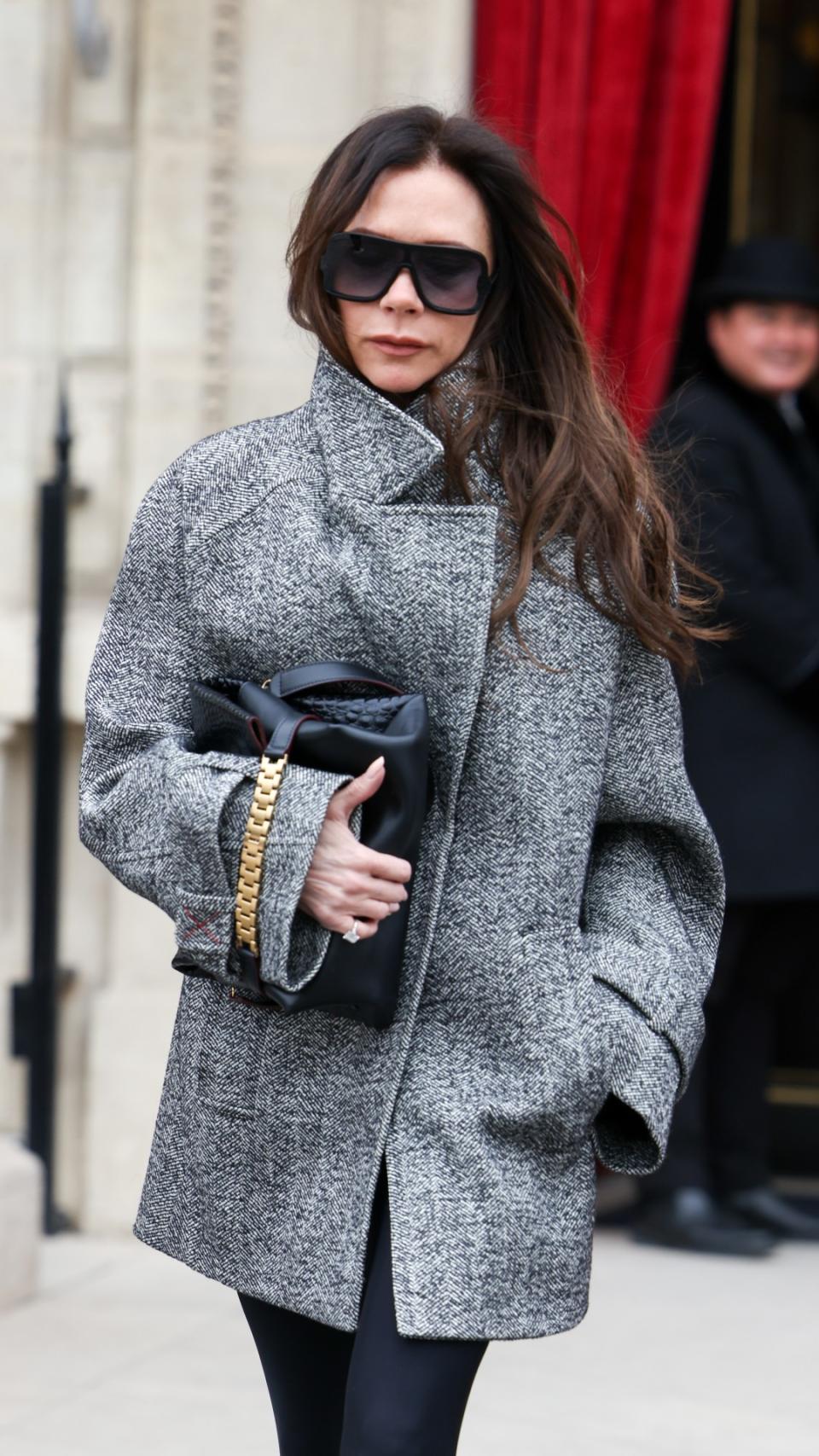 Victoria Beckham wearing a grey coat and huge sunglasses