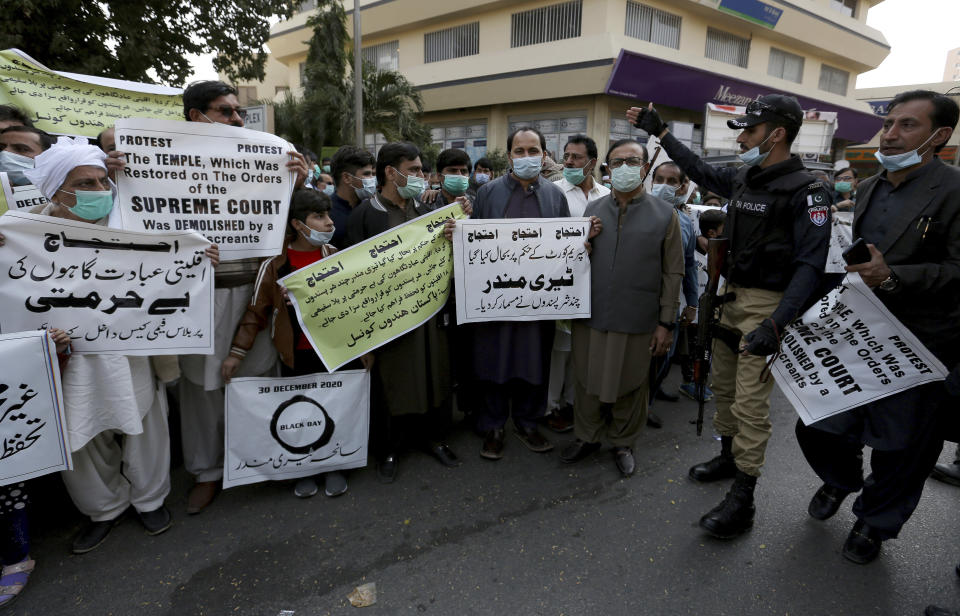 Members of Pakistan Hindu Council hold a protest against the attack on a Hindu temple in the northwestern town of Karak, in Karachi, Pakistan, Thursday, Dec. 31, 2020. Pakistani police arrested 14 people in overnight raids after a Hindu temple was set on fire and demolished by a mob led by supporters of a radical Islamist party, officials said. The temple's destruction Wednesday in the northwestern town of Karak drew condemnation from human rights activists and the minority Hindu community. (AP Photo/Fareed Khan)